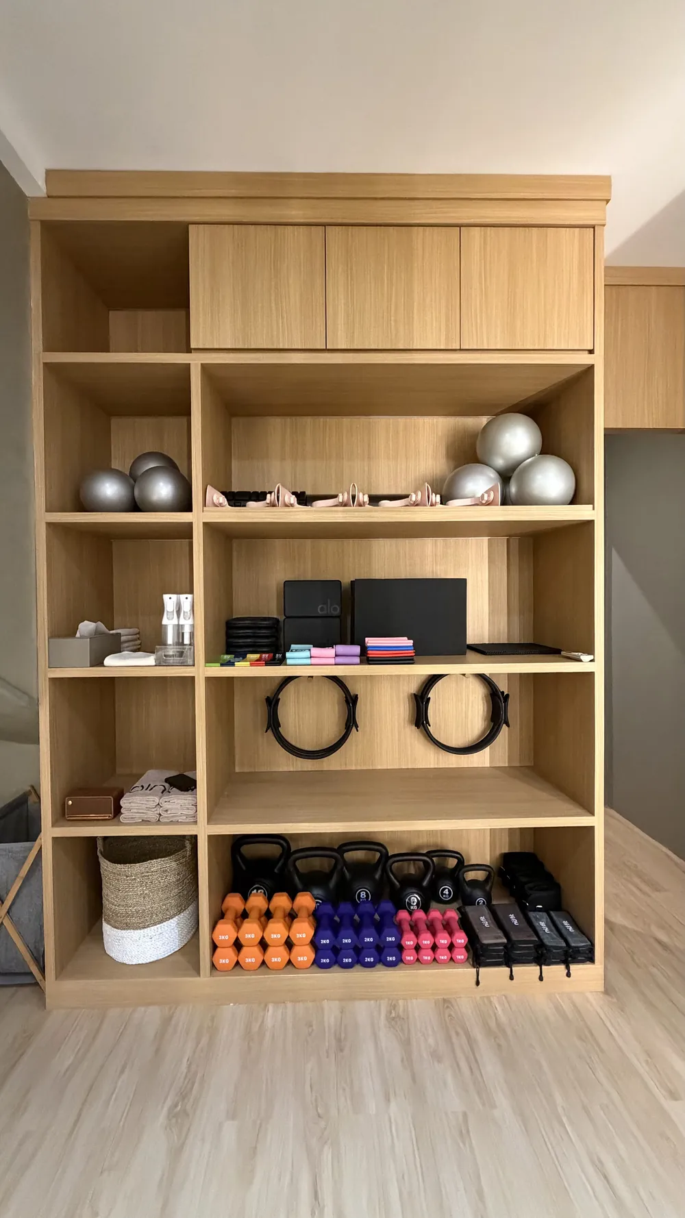 Oak shelving with Pilates rings, balls, weights and grip socks